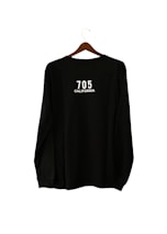 A black long-sleeve shirt is hanging on a wooden hanger. The text '705 CALIFORNIA' is printed in white on the back of the shirt.