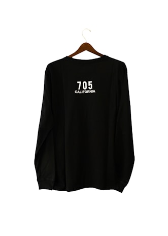 A black long-sleeve shirt is hanging on a wooden hanger. The text '705 CALIFORNIA' is printed in white on the back of the shirt.