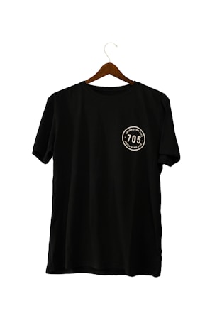 A black T-shirt hanging on a wooden hanger, featuring a circular emblem with the number '705' and the words 'seven zero five' twice around it.