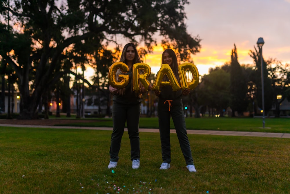 man and woman standing on green grass field during daytime