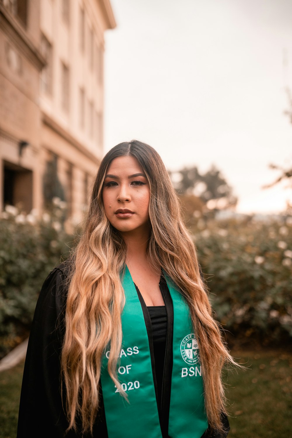 woman in black cardigan standing near brown building during daytime