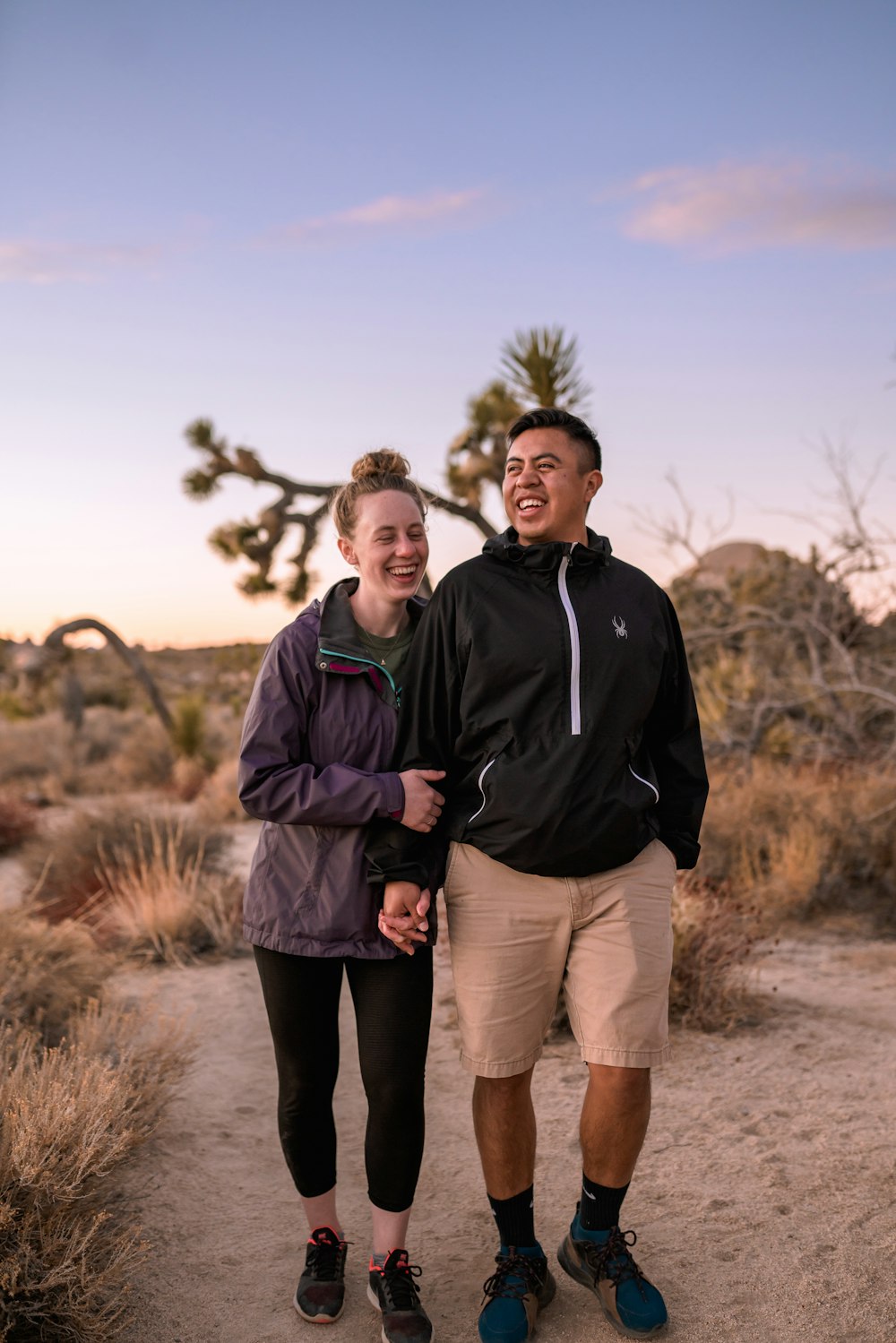 man in black jacket standing beside woman in black jacket