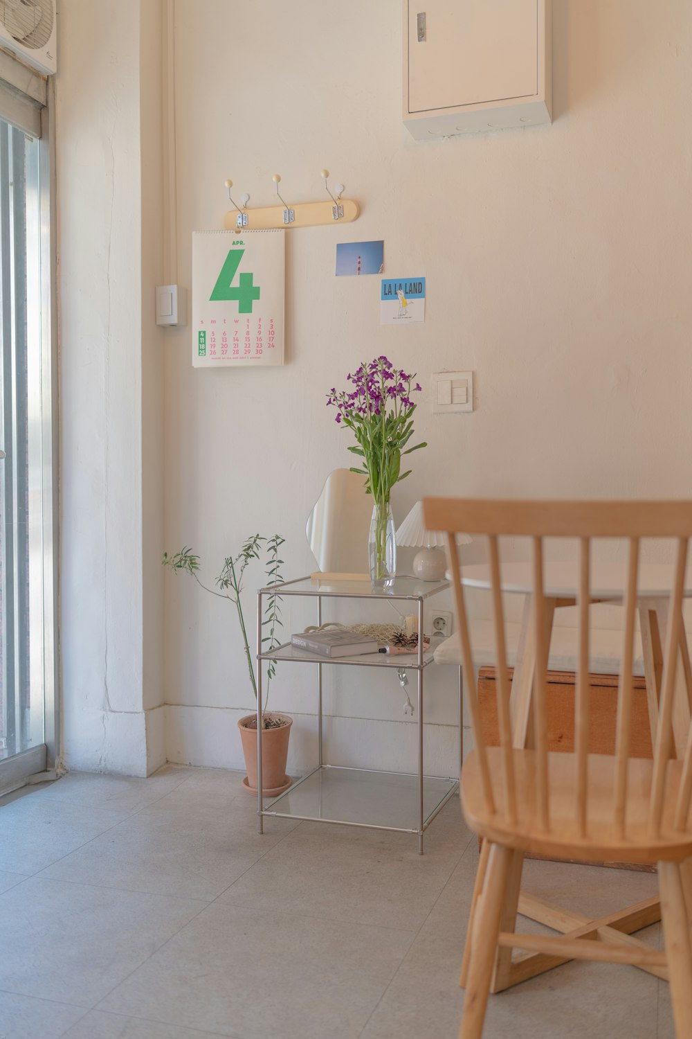 brown wooden chair beside green potted plant