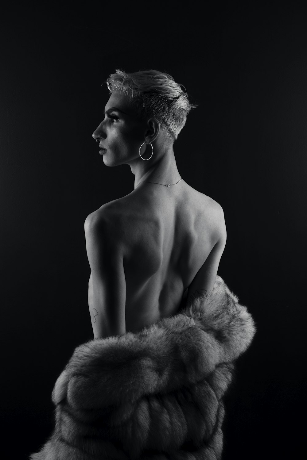 topless woman in fur coat