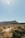 A runner navigating a rocky trail surrounded by arid landscapes.