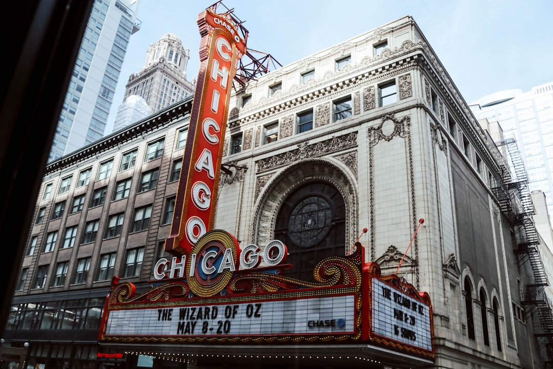 the chicago theater marquee on the corner of a city street, Photo of The Chicago Theatre in downtown Chicago