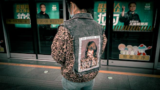 Dynamic shot of a young New Yorker wearing a comeback city jacket, walking through a busy subway station.