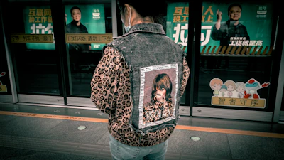 Dynamic shot of a young New Yorker wearing a comeback city jacket, walking through a busy subway station.