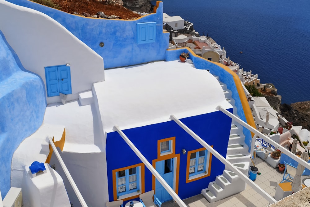 white and blue concrete building near body of water during daytime