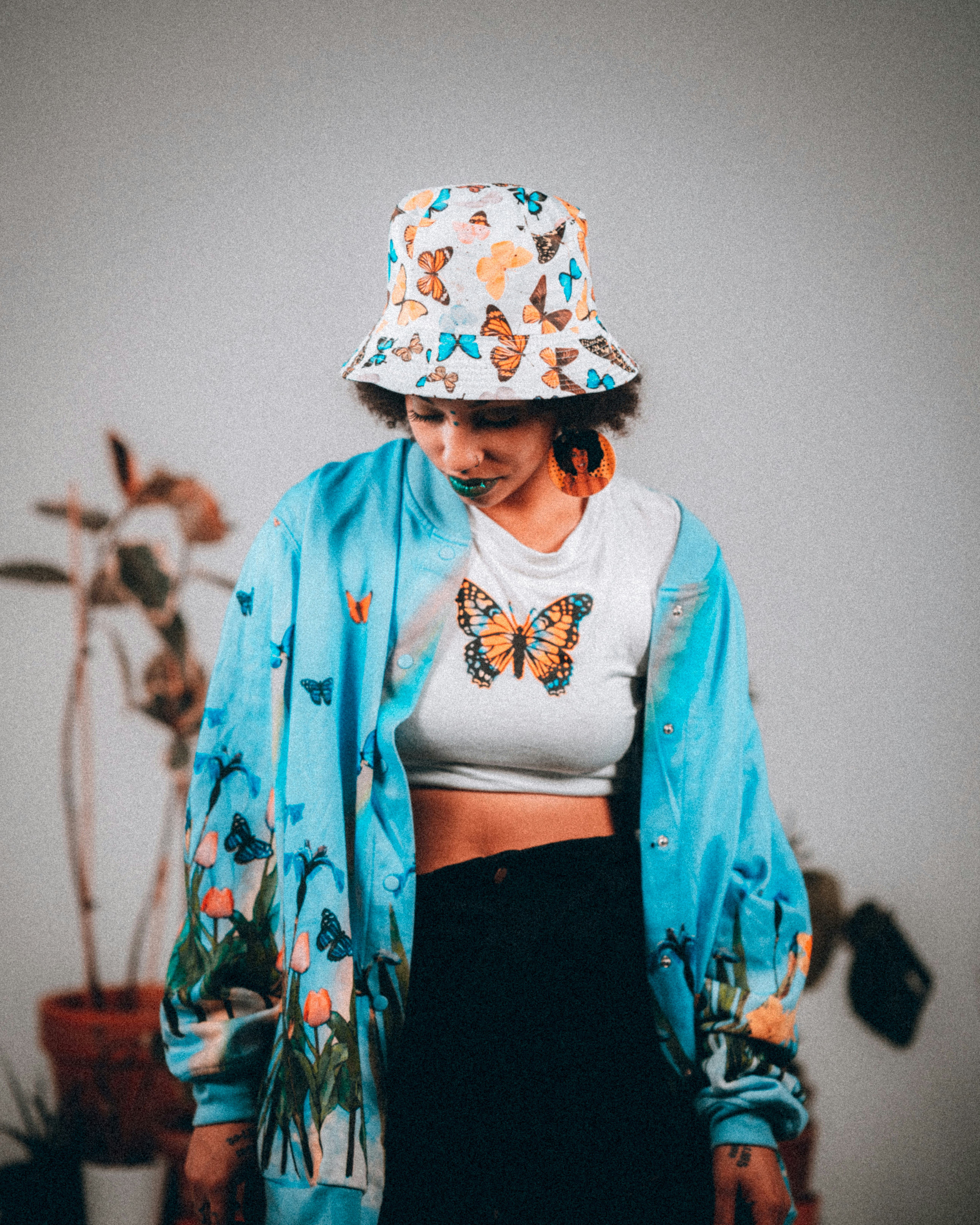 woman in blue and white floral long sleeve shirt and black skirt