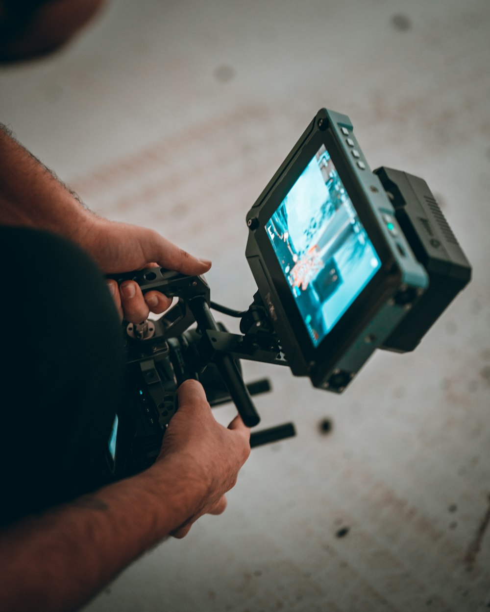 person holding black video camera