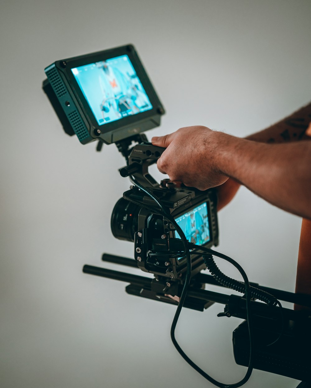 person holding black video camera