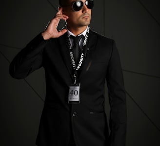 man in black suit wearing black sunglasses