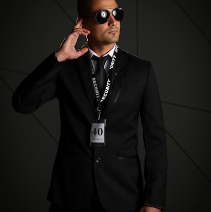 man in black suit wearing black sunglasses