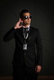 man in black suit wearing black sunglasses