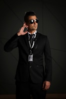 man in black suit wearing black sunglasses