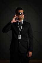 man in black suit wearing black sunglasses