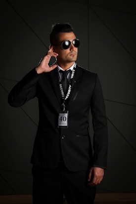 man in black suit wearing black sunglasses