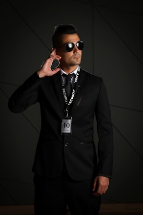 man in black suit wearing black sunglasses