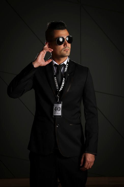 man in black suit wearing black sunglasses