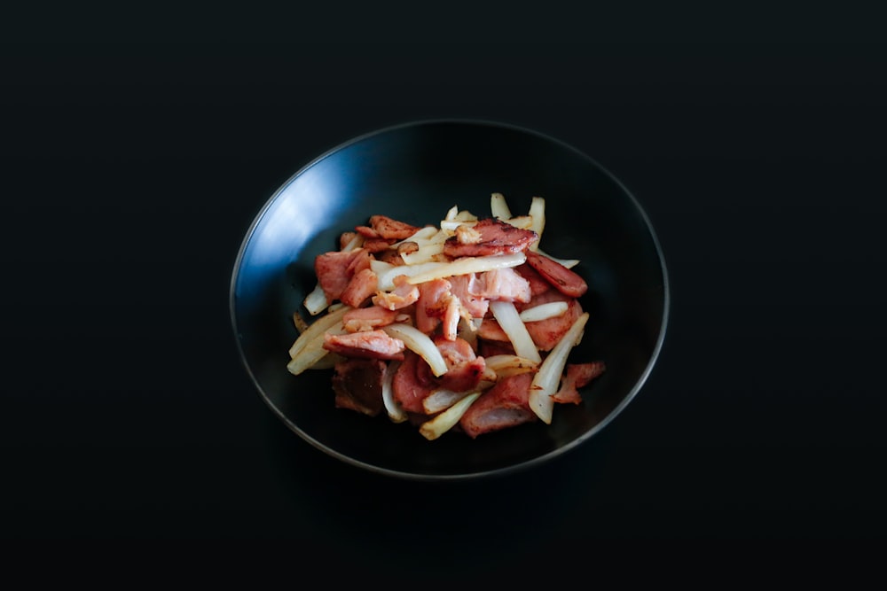 cooked food on black round plate