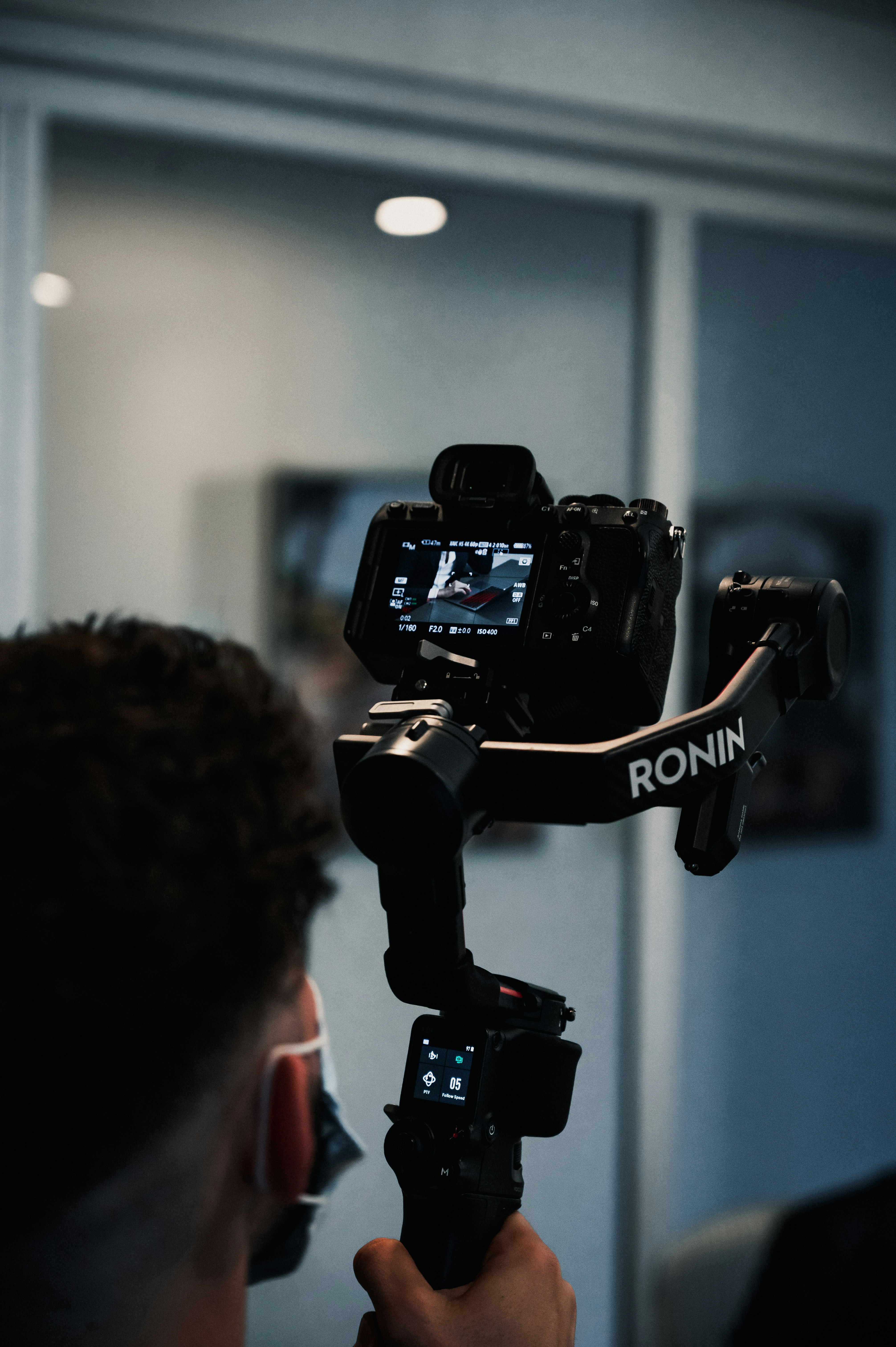 A DSLR camera on a gimbal stabilizer for documentary-style video production.