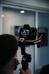 man holding black dslr camera