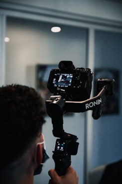 man holding black dslr camera