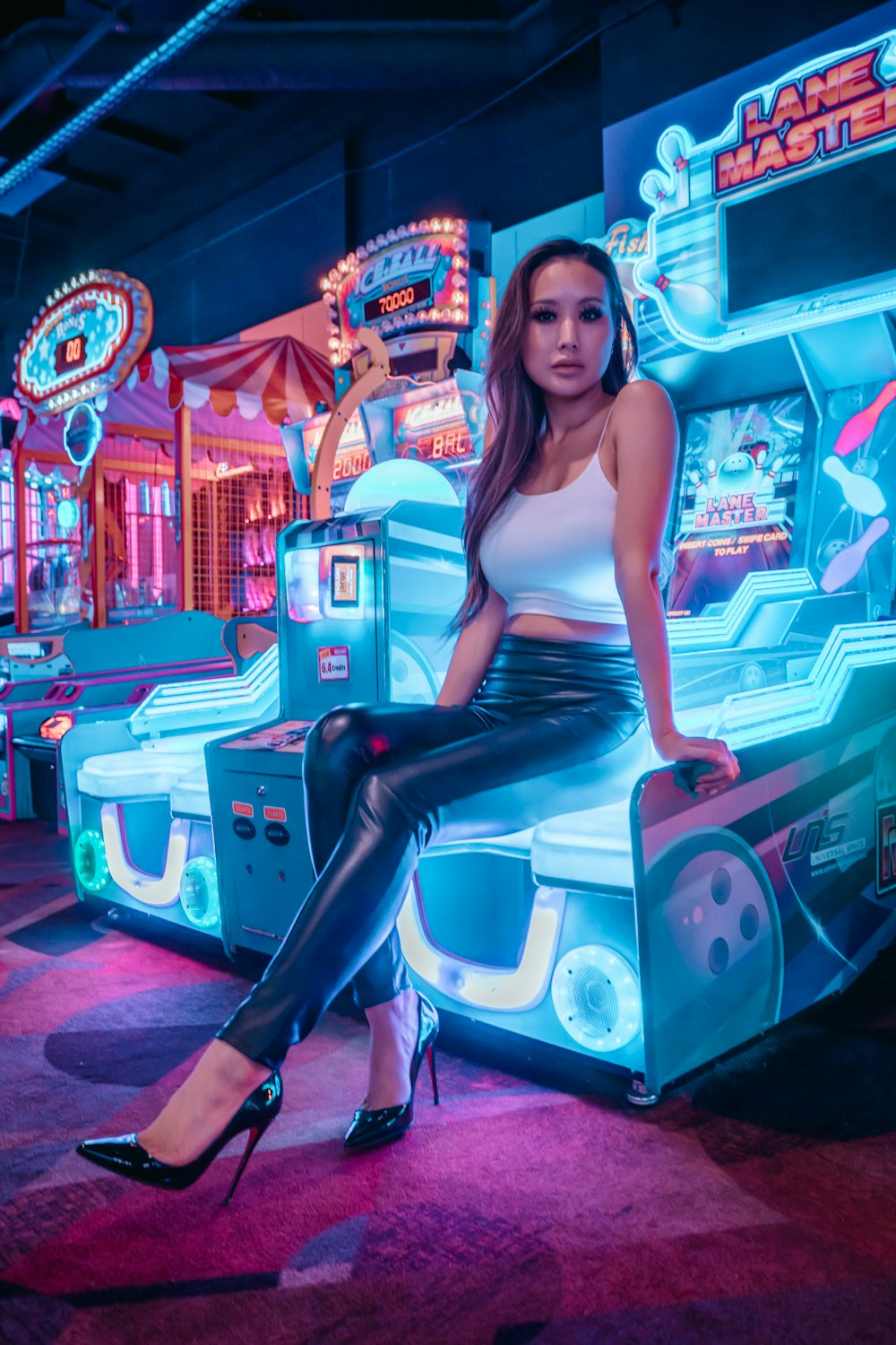 woman in blue tank top and black pants sitting on white plastic seat