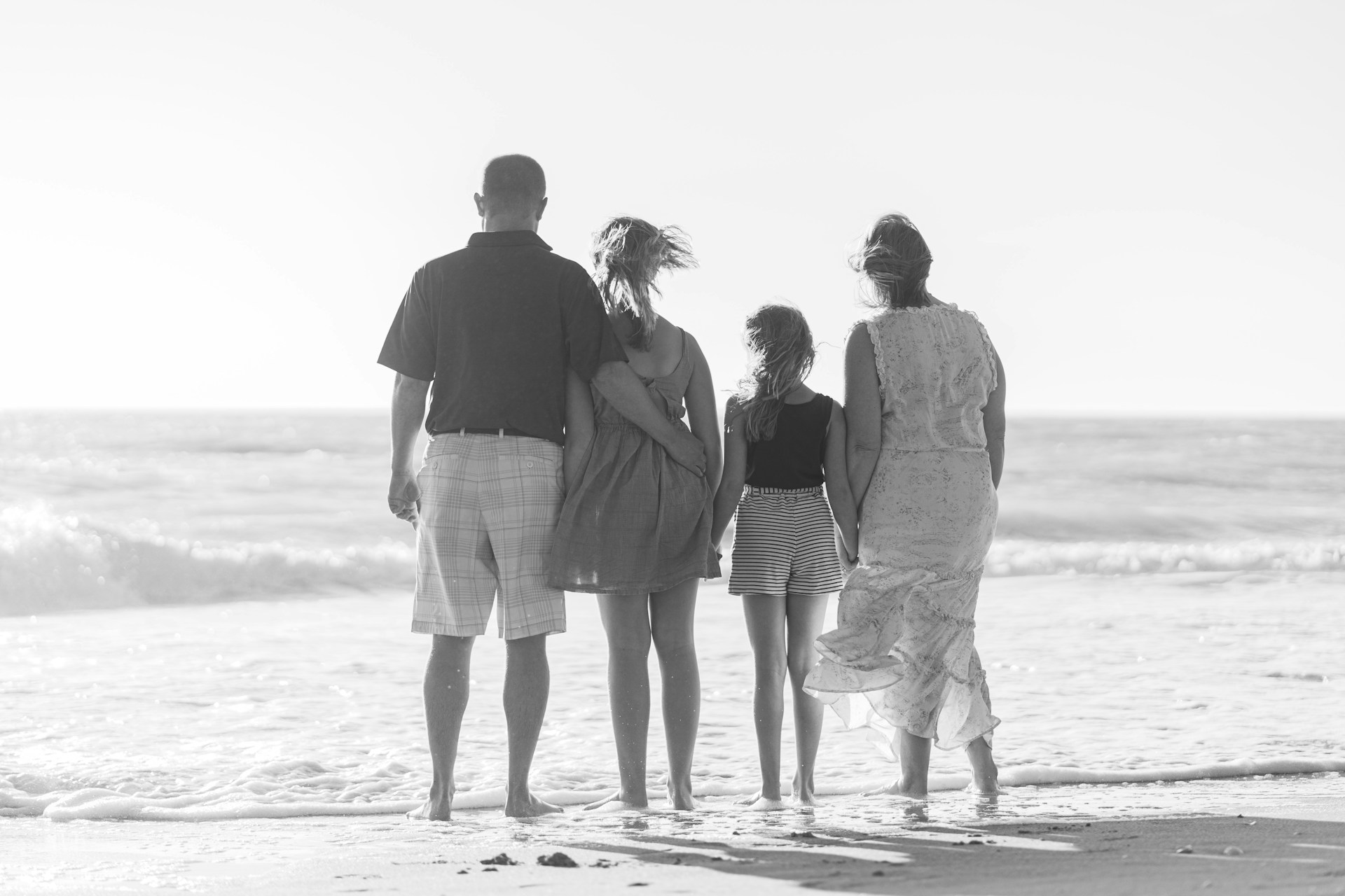 man and woman walking on beach during daytime