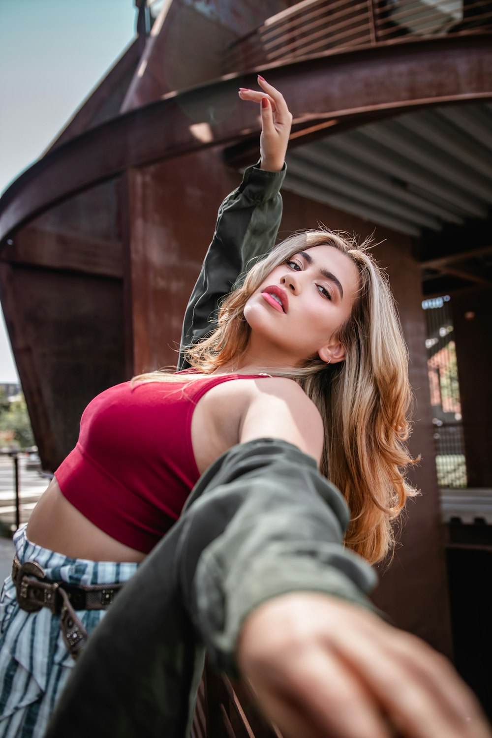 woman in red tank top and gray jacket