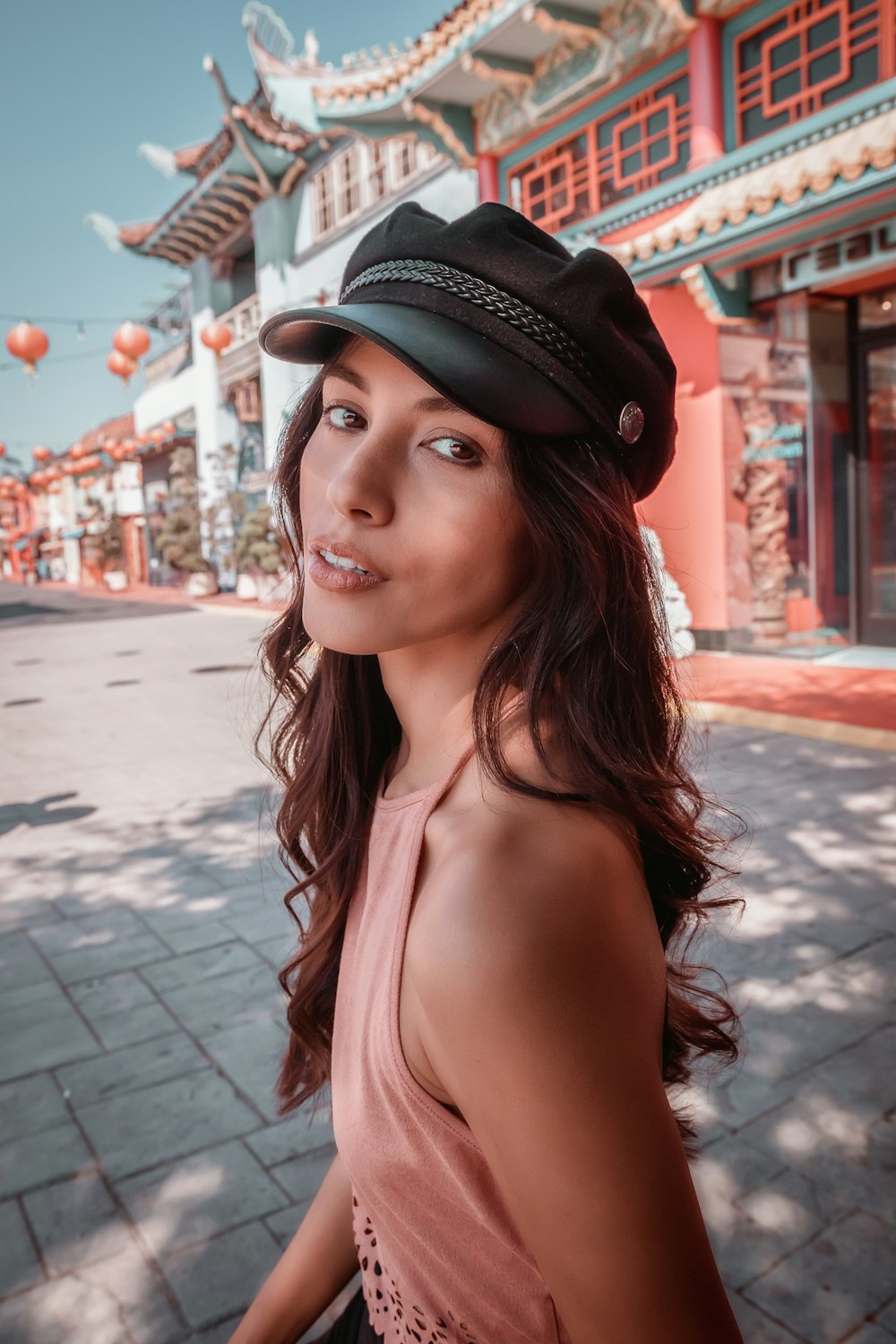 woman in black hat and white tank top