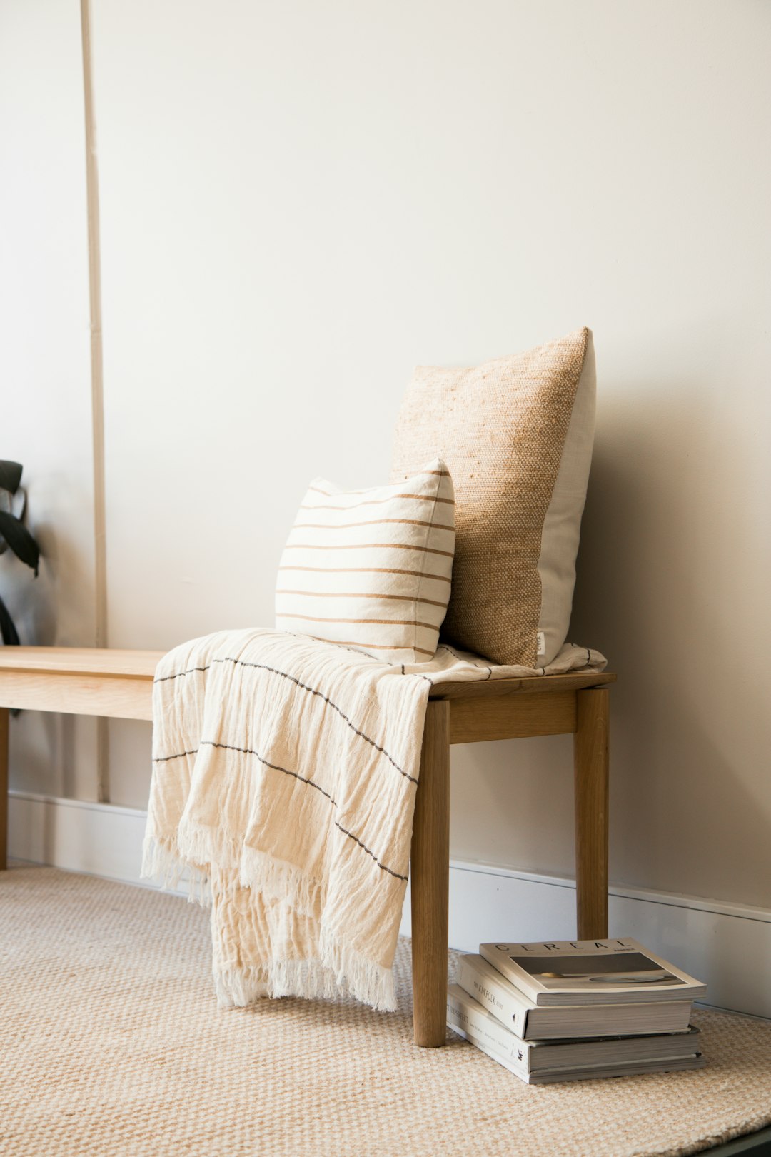 white and brown throw pillow on brown wooden chair