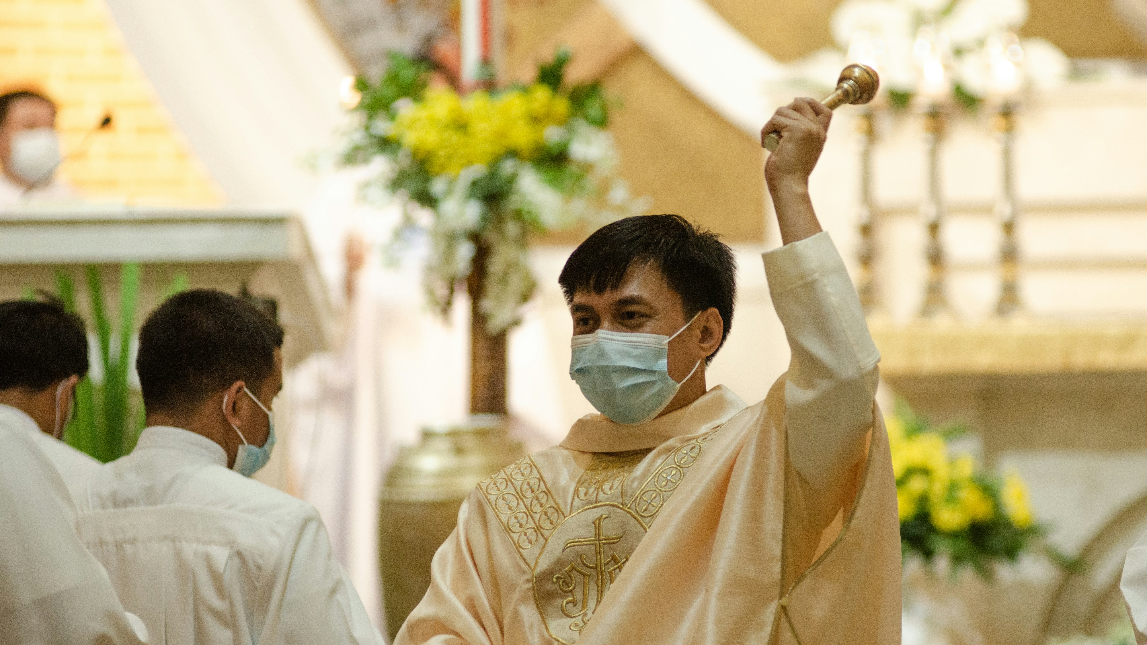 man in white dress shirt wearing white mask