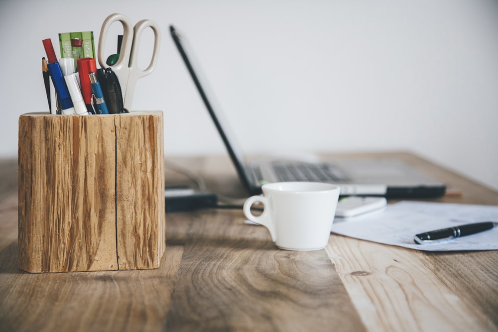 white ceramic mug on brown wooden table