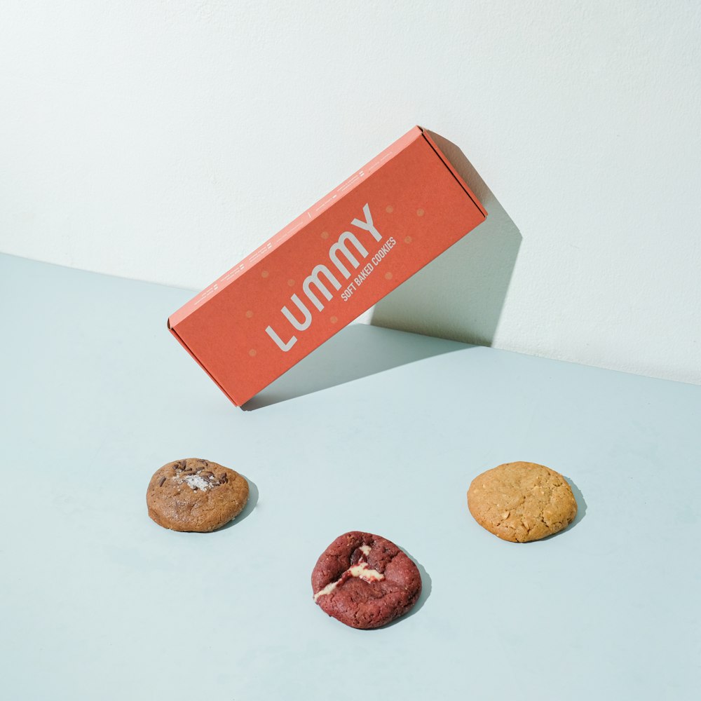 red and white box beside brown round coins