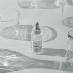 Close-up of a male influencer’s skincare products arranged neatly on a minimalist white table.