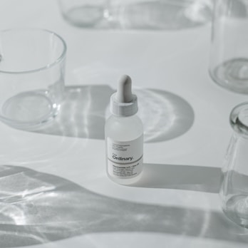 Elegant arrangement of skincare bottles with rounded edges on a white background with soft shadows.