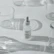 Elegant flat lay of minimalist skincare bottles on a white marble surface with soft shadows.