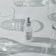 A minimalist arrangement featuring a dropper bottle of skincare product, surrounded by clear, empty glass containers casting soft shadows on a white surface.