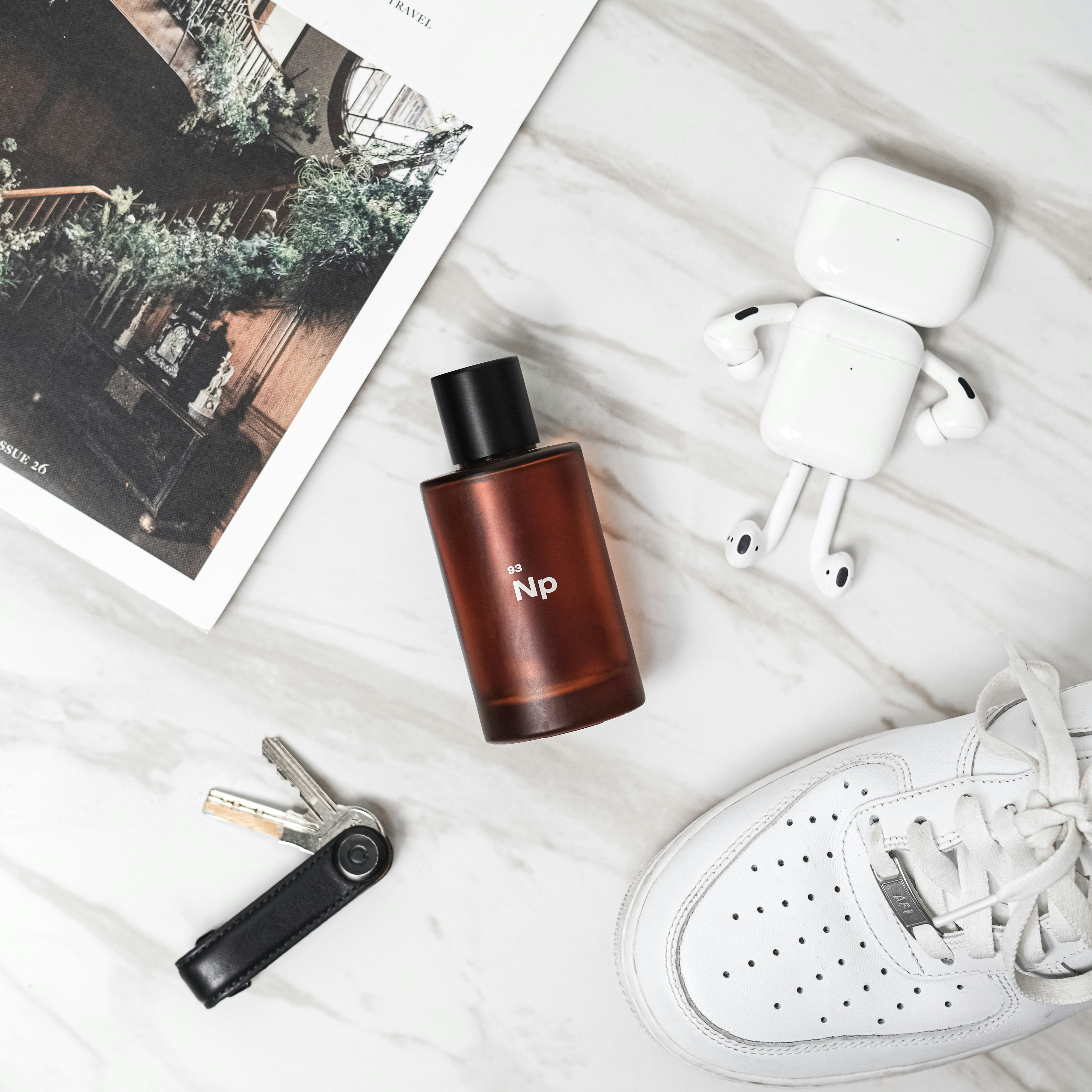 white apple earpods beside brown and black bottle