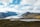 brown and green mountains under white clouds and blue sky during daytime