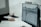 A person working at a desk with a computer monitor displaying a detailed technical drawing or architectural blueprint. The background is blurred, focusing on the screen with the design.