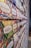 A wall displaying an assortment of colorful coffee packages, each labeled with different country origins such as Ecuador, Guatemala, Brazil, and others. The packages feature vibrant, abstract designs that are visually striking.