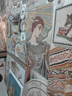 A vibrant mosaic blending symbols from Greek and Georgian mythology, with intricate patterns and mythical creatures intertwined.