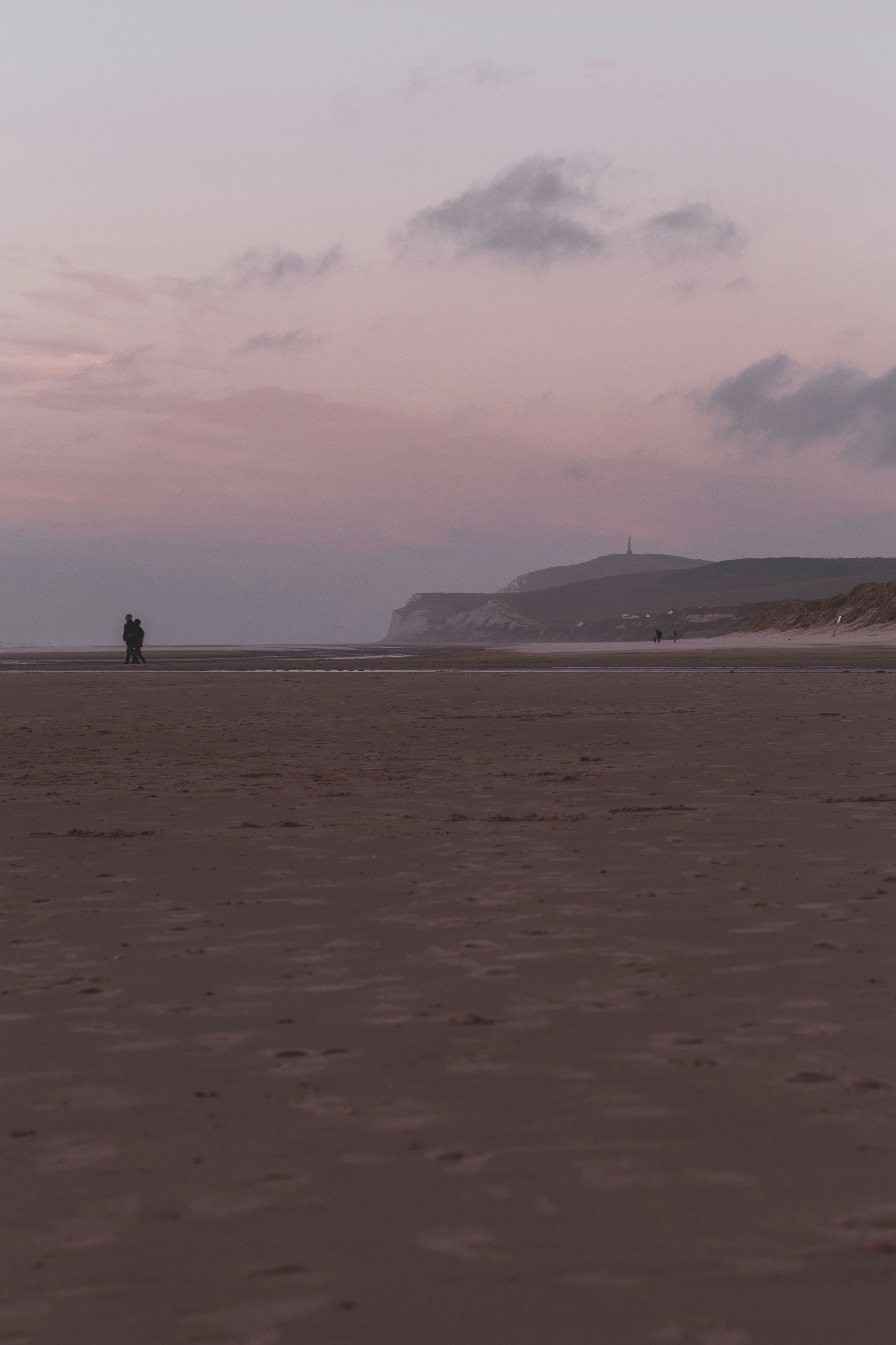 2 person walking on beach during daytime
