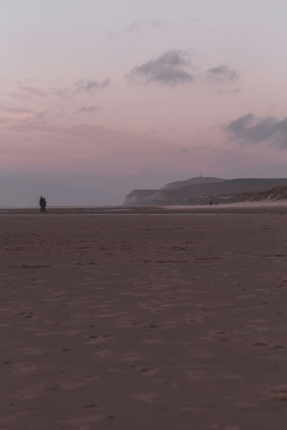 2 person walking on beach during daytime