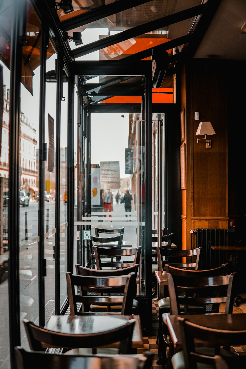 brown wooden chairs and table near glass window