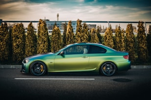 green porsche 911 parked on parking lot during daytime