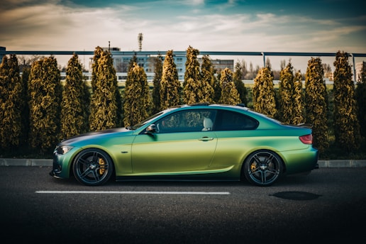 green porsche 911 parked on parking lot during daytime